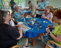Members making clay flowers for District X Meeting