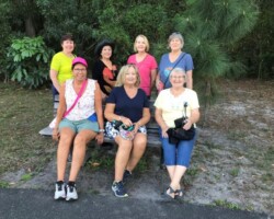 Strollers relaxing by Bexley Park pond